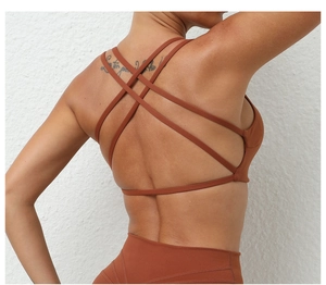Detail of cross-back straps on breathable yoga bra for women in coffee brown