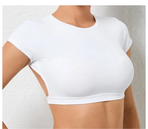 Close-up of slim-fit white yoga crop top with cutout waist and breathable side vents