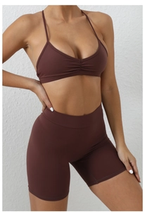 Detail view of chocolate brown quick-dry yoga set with ruched bra and high waist shorts