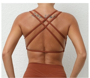 Macro detail of the cross-back straps on this caramel breathable sports yoga bra