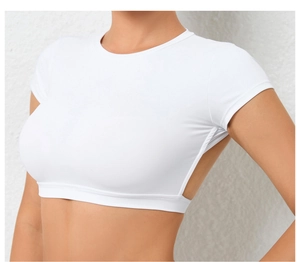 Detail view of a white short sleeve crop top with open back for yoga and fitness