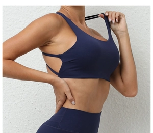 Detail view showing cross-back thin straps of a navy blue quick-dry sports bra