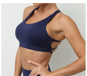 Detail of dark blue sports bra featuring a racerback and breathable side cut-outs