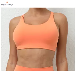 Close-up of seamless bright orange sports bra featuring moisture-wicking fabric and double straps