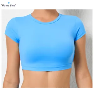 Back view of flame blue tight yoga top showing seamless athletic fit and short sleeves