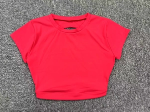 Flat lay of pink crop top featuring a crew neck and half-moon back cutout detail