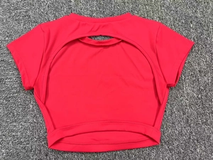 Detail of red athletic crop top with an oval back cutout and high neck seam