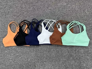 Detailed flat lay of quick-dry yoga bras in multiple colors with crisscross back design