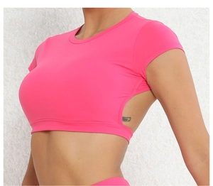 Dettaglio del top da yoga rosa con ritaglio laterale e tessuto ad alta elasticità