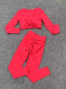 Détails d'un ensemble de yoga rouge à manches longues avec haut en V et legging froncé