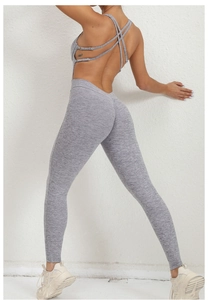 Close-up back view of grey cross-strap backless yoga jumpsuit with peach lift leggings
