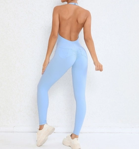 Rear view of light blue backless yoga jumpsuit showing peach lift seams and pockets