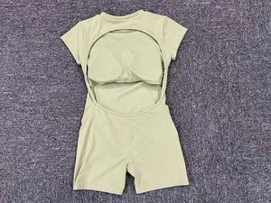 Detail view of backless yoga bodysuit with built-in pads and short sleeves in light green