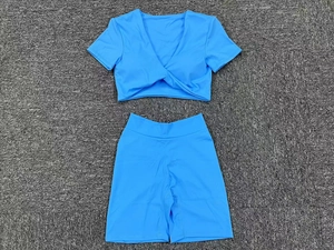 Blaues zweiteiliges Yoga-Set mit V-Ausschnitt-Oberteil und Shorts in Flachbildaufnahme