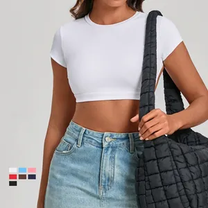 Tight white cropped yoga top and denim skirt set with a black quilted tote bag