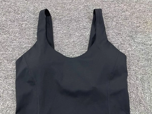 Close-up of seamless black yoga bodysuit with reinforced flatlock stitching and wide straps