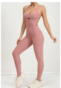 Detail of cross straps and back cutout on the mauve pink athletic yoga bodysuit