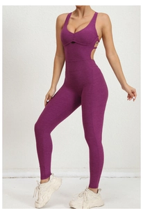 Detail showing the deep purple yoga jumpsuit with crossover straps and back cut-out