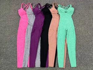 Flat lay of six colorful yoga bodysuits showing cross-back straps and knit fabric texture