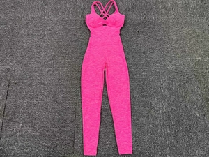 Detail of cross back straps on hot pink one-piece yoga jumpsuit with high elasticity