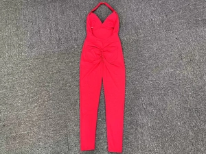 Detail of red halter yoga jumpsuit featuring backless design and ruched booty texture