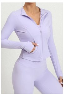 Detail of lavender running jacket featuring thumbhole cuffs and ergonomic seam stitching