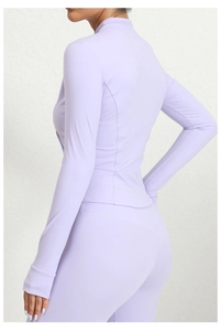 Detail of lavender slim fit sports jacket with thumb holes and matching high waist leggings