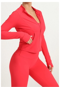Detail view of red athletic jacket with stand collar, hidden pockets and thumbholes