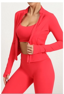 Close-up of red zip-up sports jacket sleeve showing elastic fabric and thumb hole detail