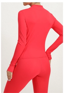 Detail view of red yoga jacket featuring ergonomic curved slim-fit back stitching