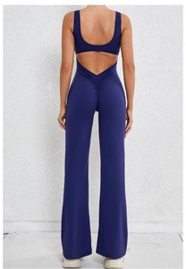 Detail of deep blue backless yoga jumpsuit with ruched waist and flare leg cut