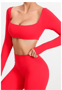 Detalle de top corto de yoga rojo de manga larga con cuello cuadrado y mallas