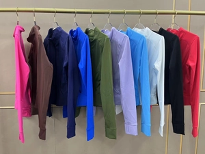 Detailed display of multi-color zip-up sports jackets with thumb holes and mock neck design