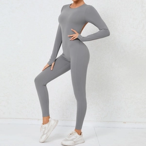Detail view of backless grey yoga jumpsuit with thumb holes and high-stretch fabric