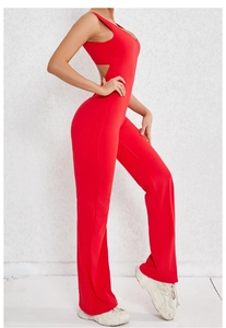 Detail of red backless yoga jumpsuit showing seamless stretch fabric and flared leg design