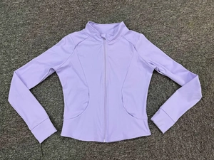 Detail view of lavender yoga jacket featuring stand-up collar and thumbhole cuffs