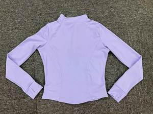 Detail of lavender running jacket featuring thumbhole cuffs and slim fit stitching