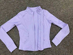 Close-up of lavender slim-fit workout jacket featuring standing collar and full zipper