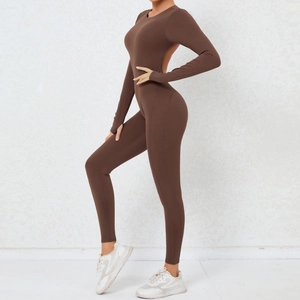 Detail of backless brown yoga jumpsuit with thumbhole cuffs and high elasticity fabric