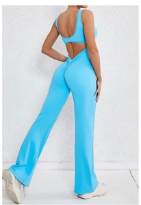 Detail of light blue backless yoga jumpsuit with flattering ruched booty and flared leg