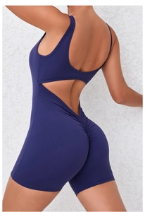 Detail view of the open-back design and scrunch butt texture on navy blue yoga jumpsuit