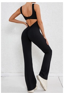Back view of black open-back yoga jumpsuit with flare pants and scrunch butt detail