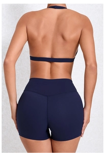 Detail eines dunkelblauen rückenfreien Sport-Bras und Yoga-Shorts mit hohem Bund