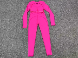Close-up of rose red yoga bodysuit featuring back cutout and integrated chest pads