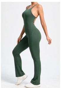 Detail of cross-back adjustable straps on a dark green flared yoga bodysuit for women