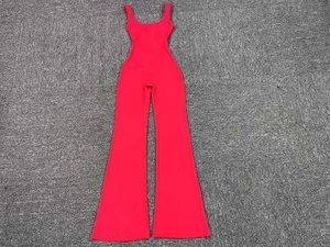 Detail view of red sleeveless jumpsuit with waist cut-outs and flared leg design