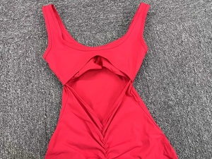 Detail of red hollow back yoga jumpsuit with scrunch butt and flared leg design