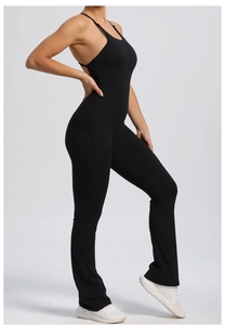 Detail of backless black athletic jumpsuit featuring adjustable straps and flared yoga pants