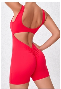 Detail of red backless yoga bodysuit featuring scrunch butt and waist cutout design