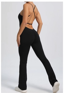 Detail of black open back yoga jumpsuit with peach lift design and flared legs